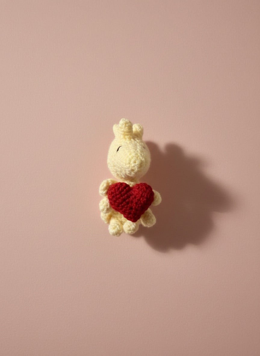 Woodstock holding a Heart