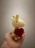 Woodstock holding a Heart